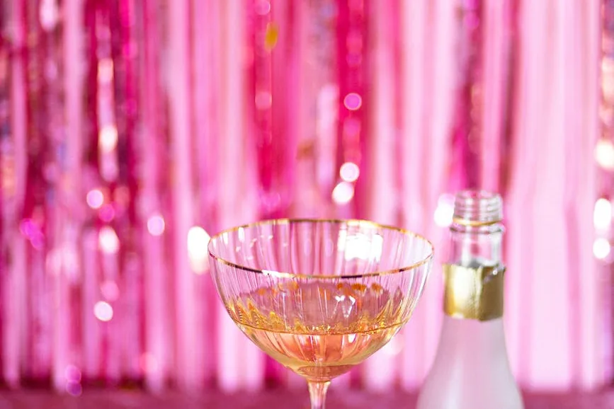 glass of wine beside a gift